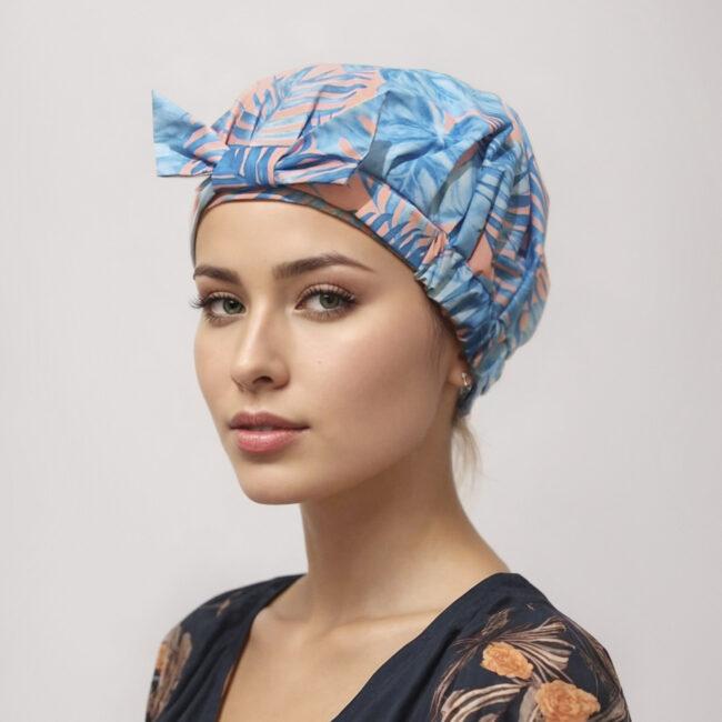 woman wearing palm pattern shower cap blue and pink