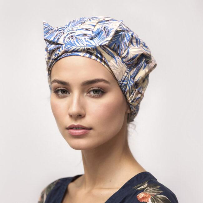 woman wearing palm print blue and yellow shower cap